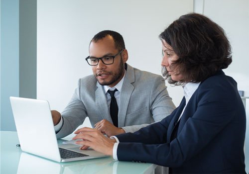 business-colleagues-reviewing-discussing-report